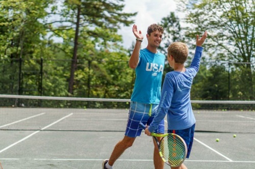 2 boys playing tennis at Camp Carolina