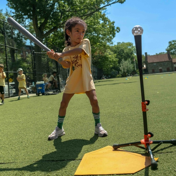 young girl playing baseball at Park Slope Day Camp