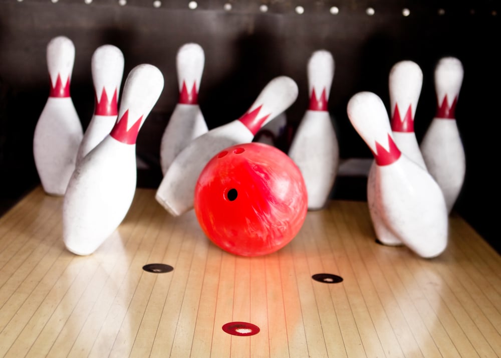Bowling strike - ball hitting pins in the alley