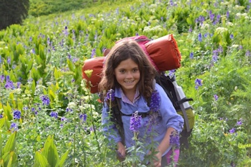 Colvig summer camps a girls hiking through some flowers-1