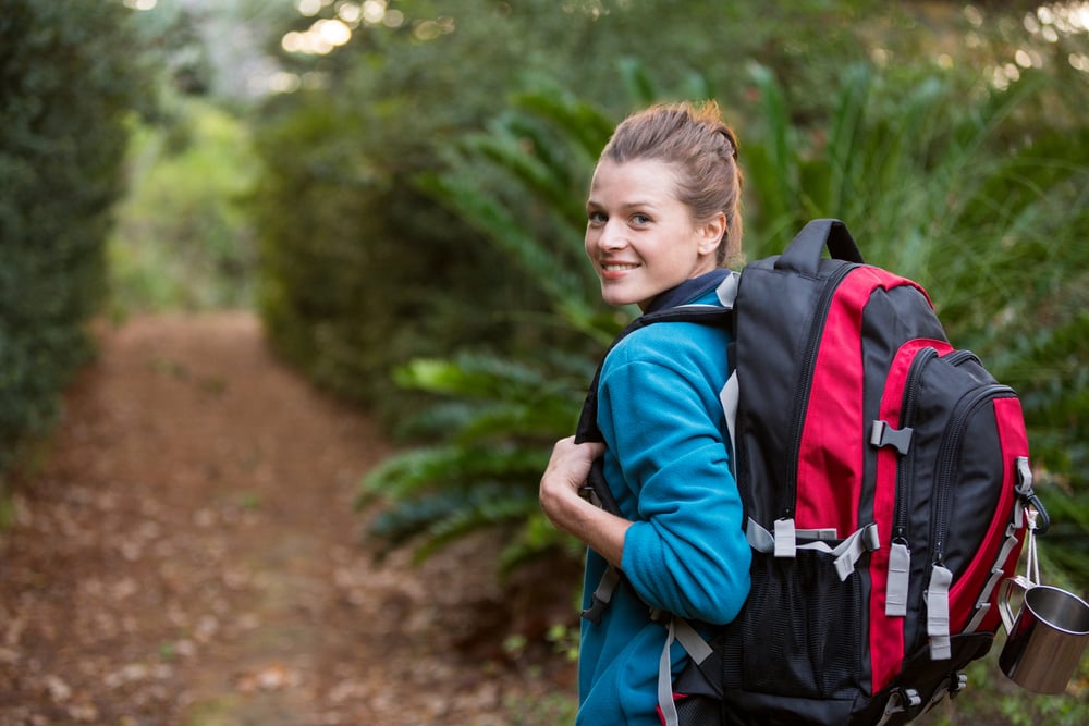 Woman hiking through a forest in the countryside
