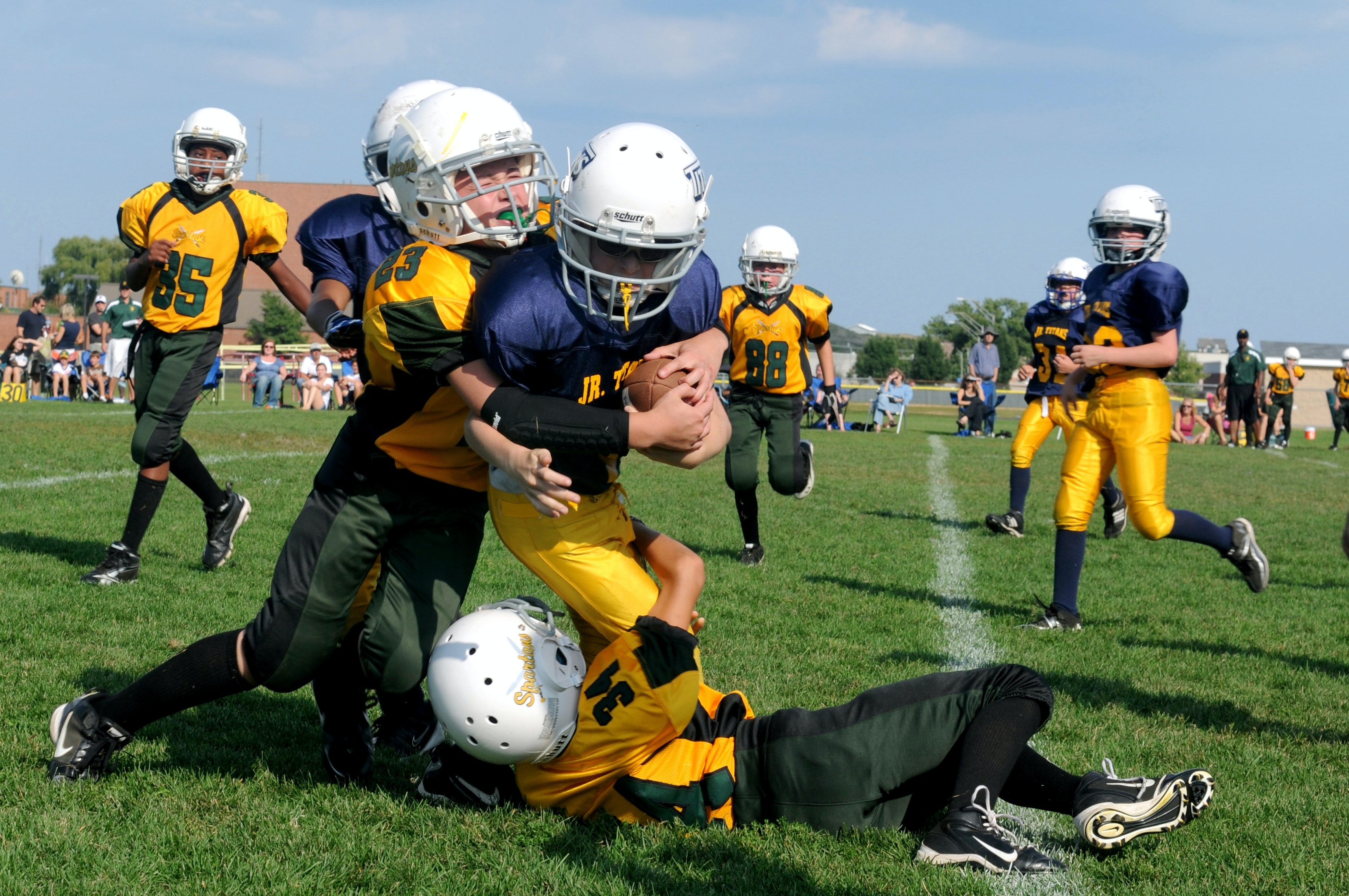 kids playing football preventing abuse in youth sports