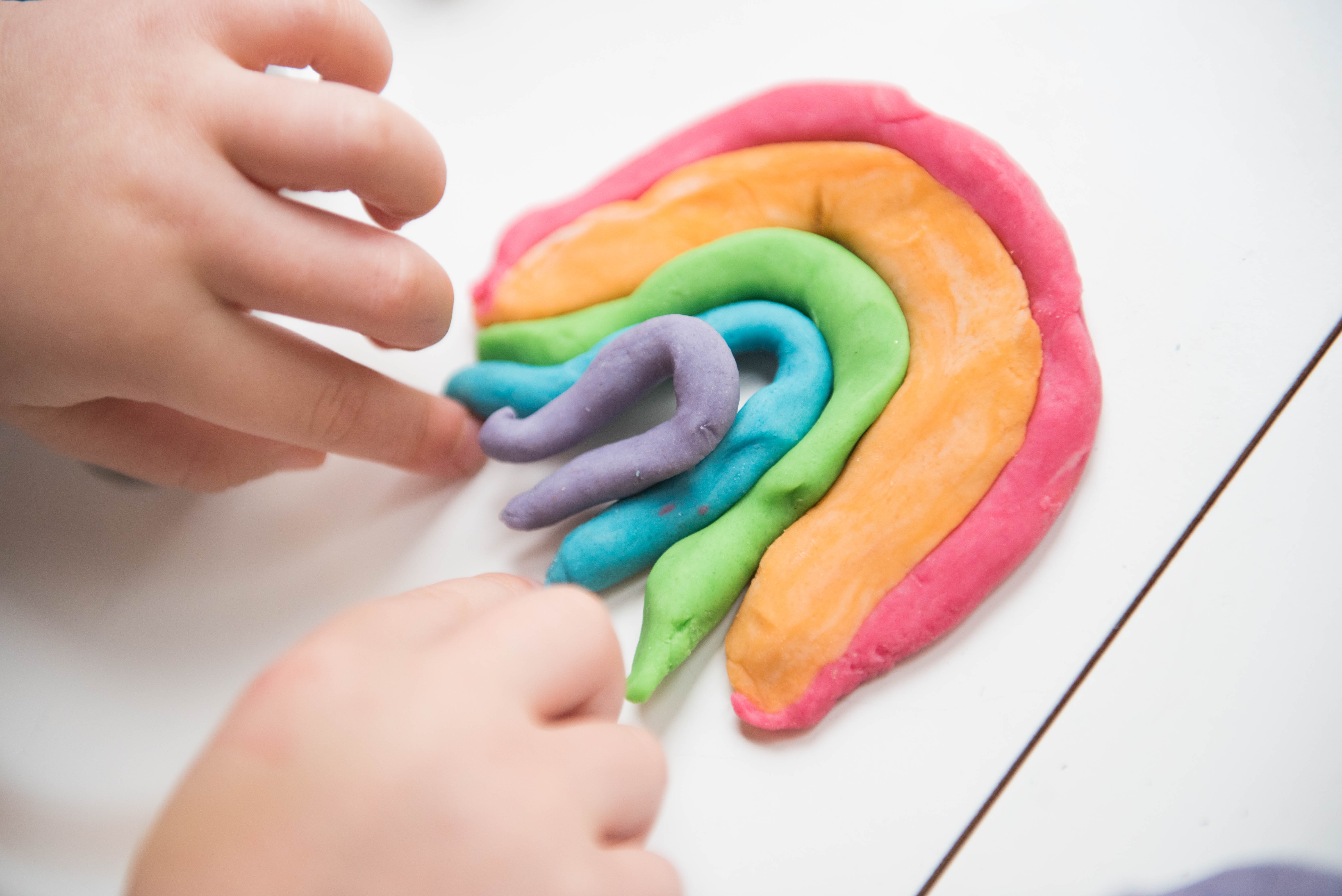 child playing with play dough inside