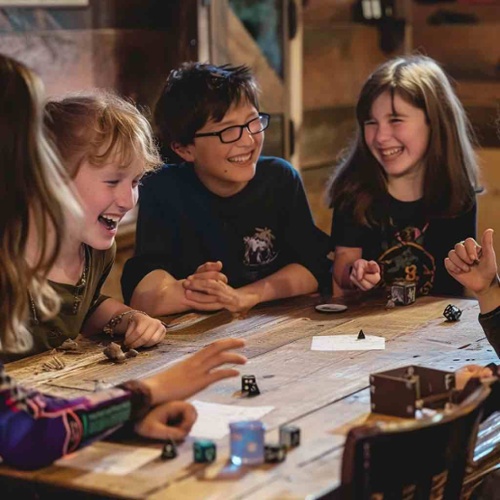 some kids sitting around a table playing dungeons and dragons-1