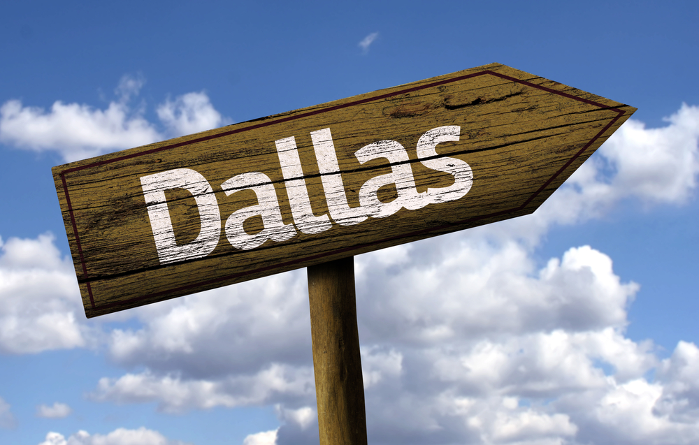 a sign showing the direction to dallas texas