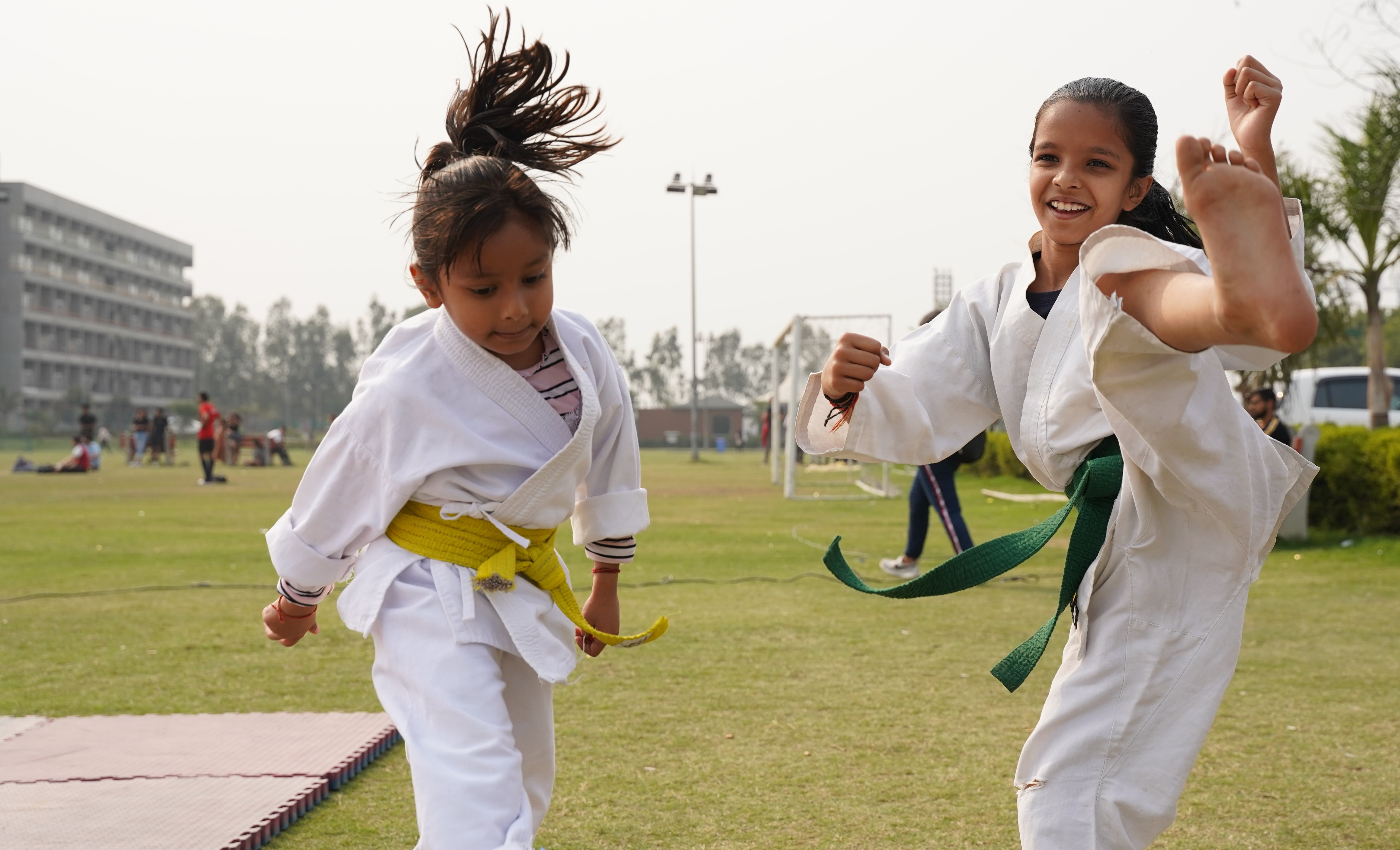 two girls doing karate as after school program ideas