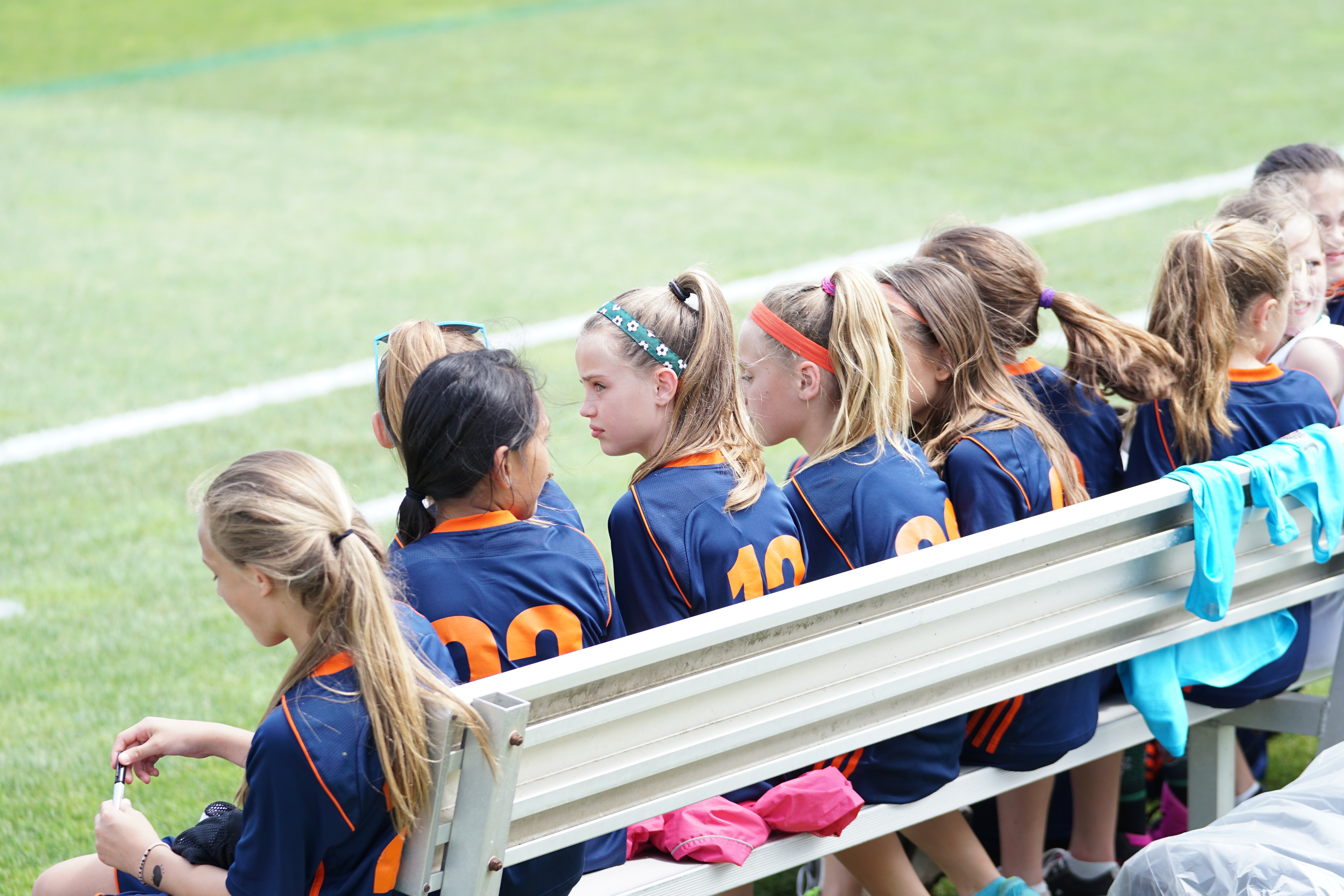 middle schoolers sitting on soccer bench for after school programs for middle schoolers